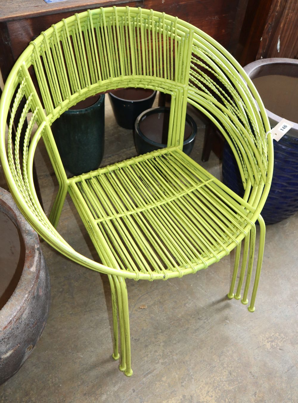 A set of four Italian painted metal stacking garden chairs
